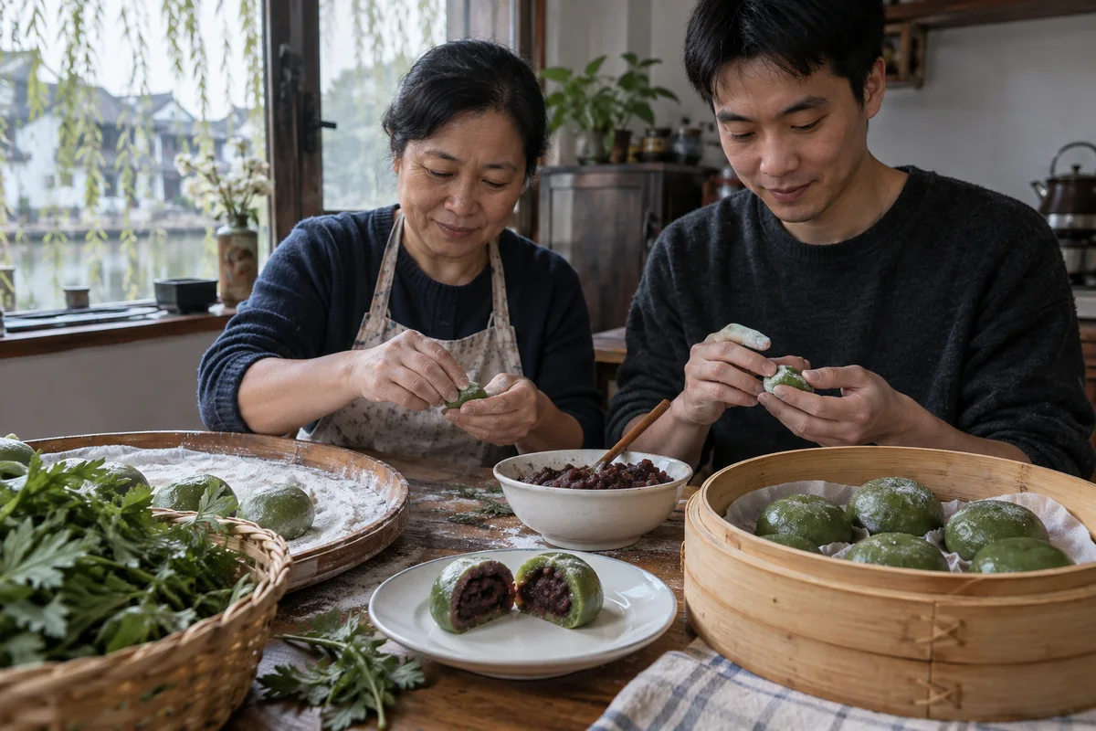Hands wrapping green qingtuan beside a bamboo steamer